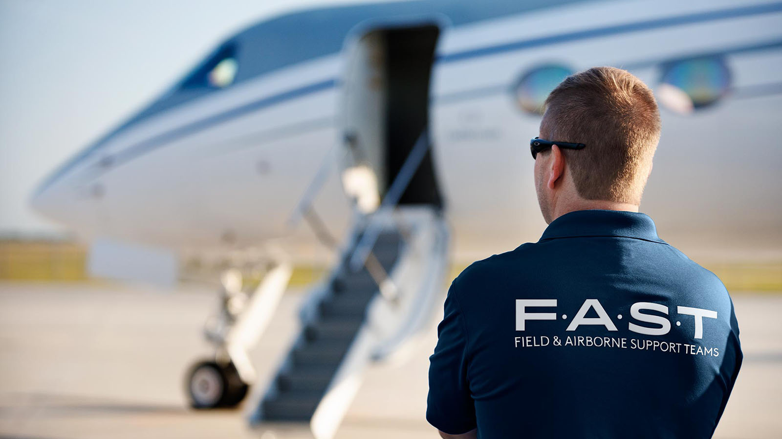 A Field & Airborne Support Team member prepares to board a FAST aircraft.