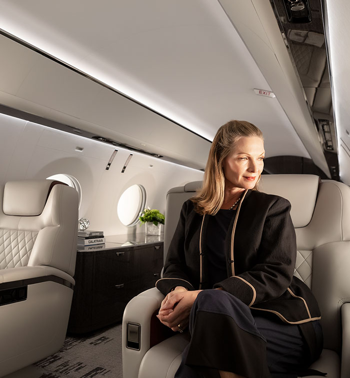 Woman seated inside aircraft with sunlight on her face