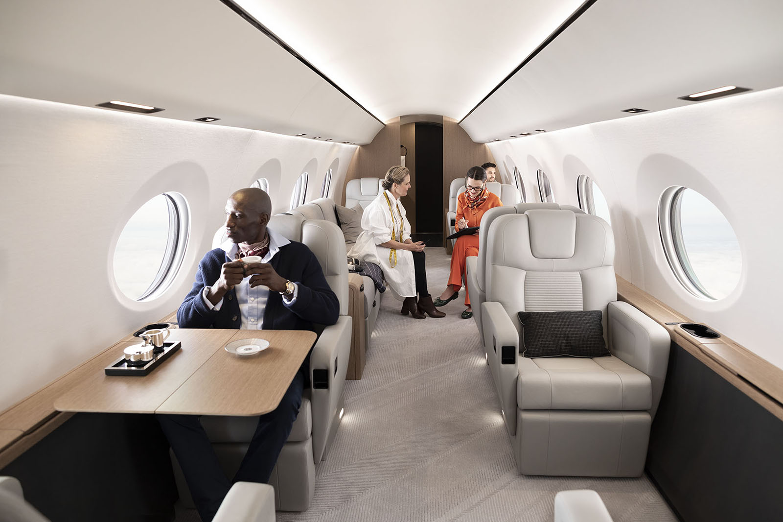 A fashion team sits in various living areas of a large G400 cabin