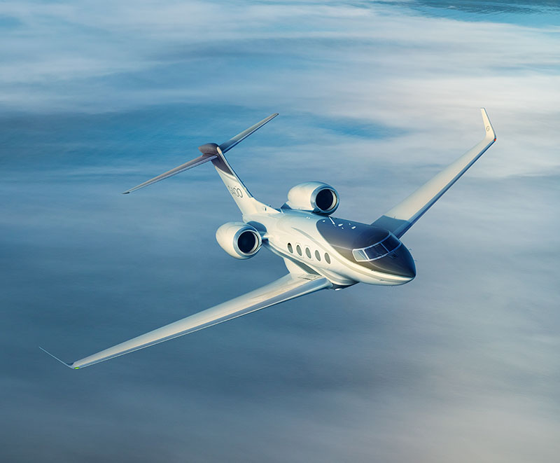A Gulfstream G400 banks over a misty sky