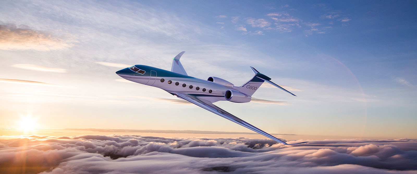 G800 banks slightly over cloudtops at sunset